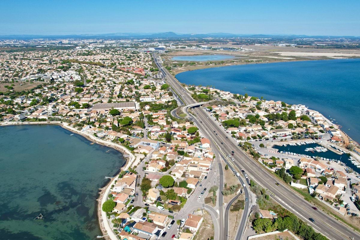Aerial view of coastal town with road and water