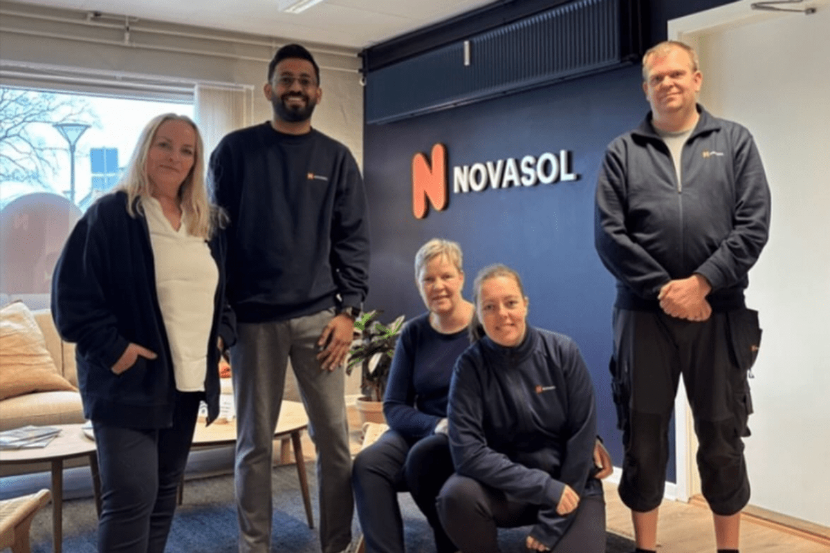One of our local office teams in Denmark, stood in front of a Novasol sign