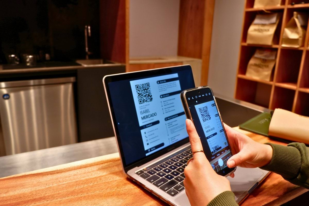 a person using a laptop and a cell phone