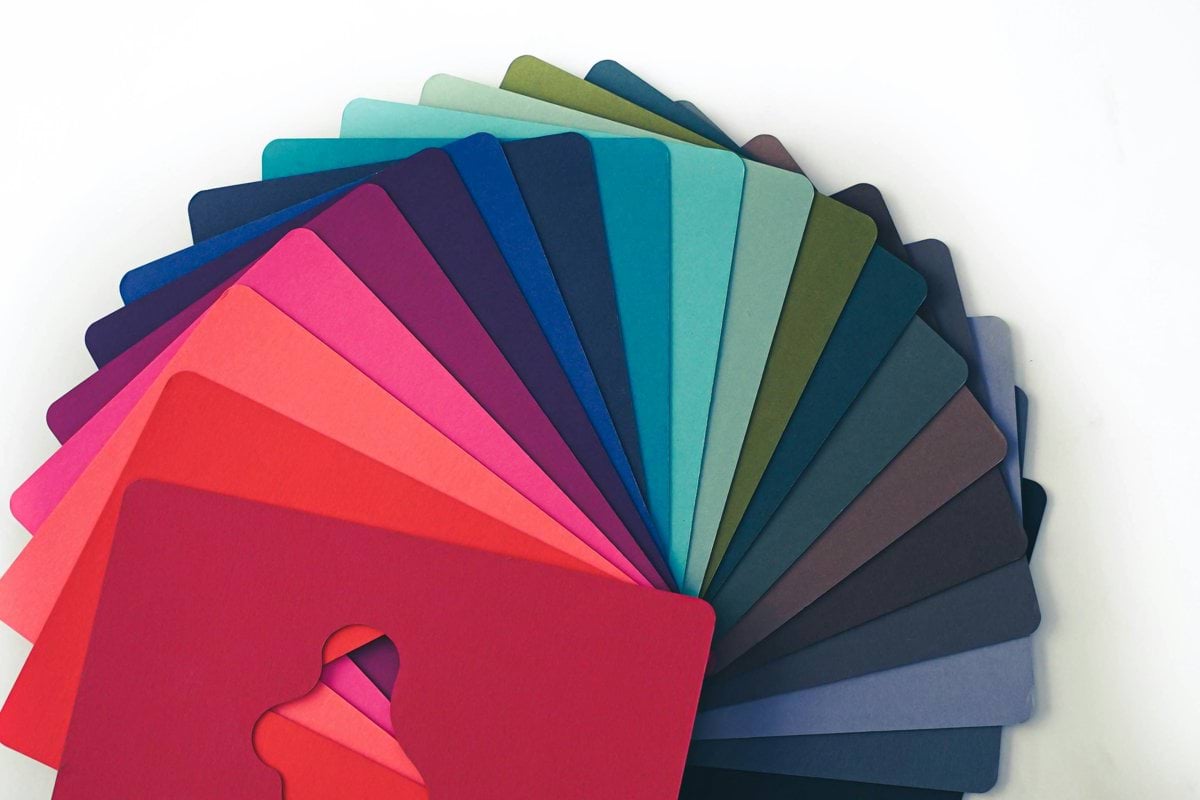 a bunch of different colors of paper on a table