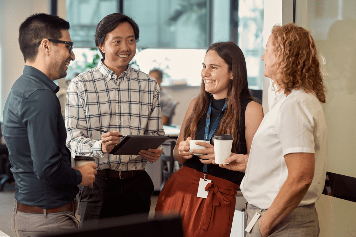 Small group of KCB young professionals interacting in the Brisbane office.