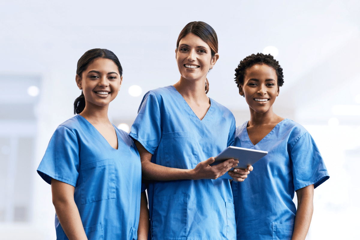 Photo of three smiling nurses.