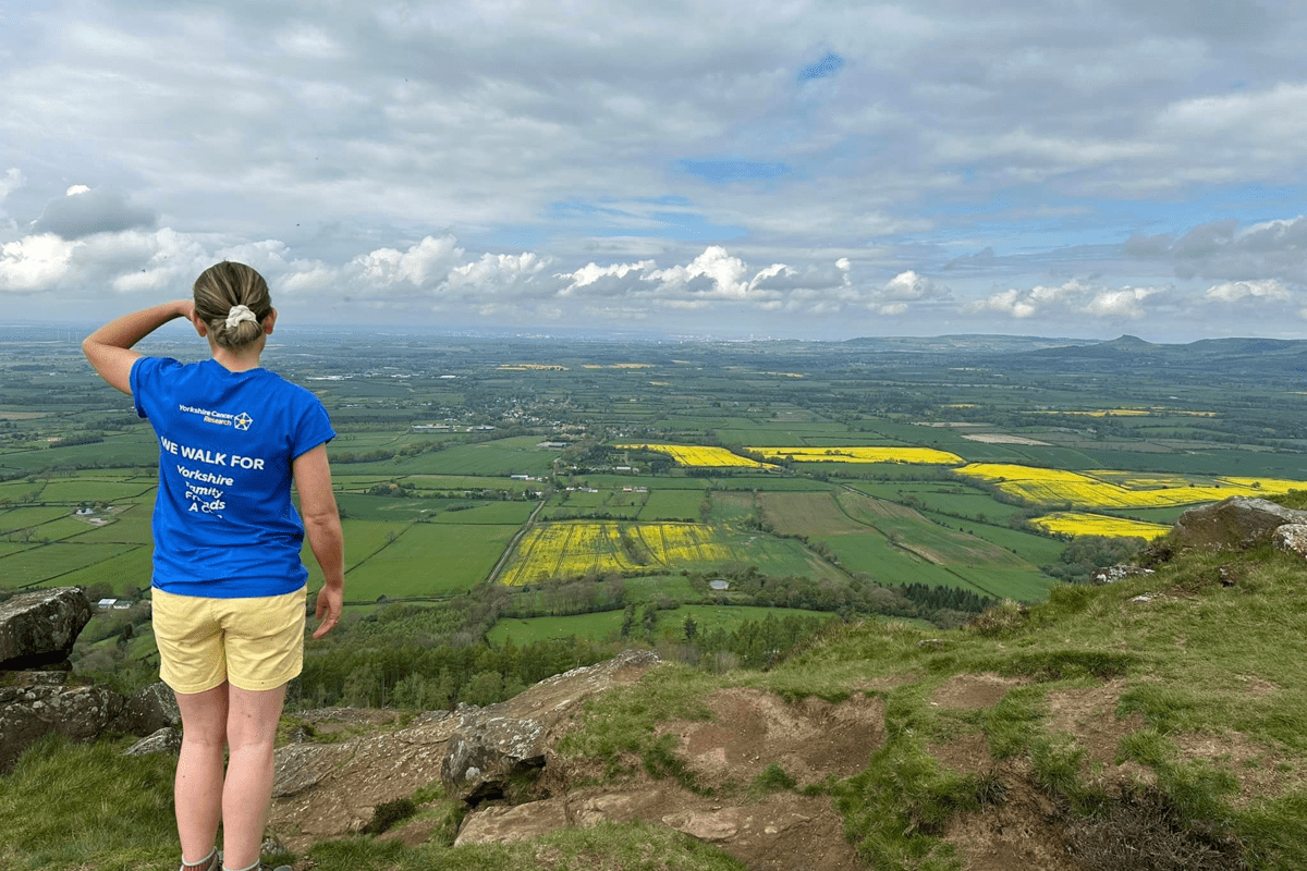 A woman looks over a typical Yorkshire countryside