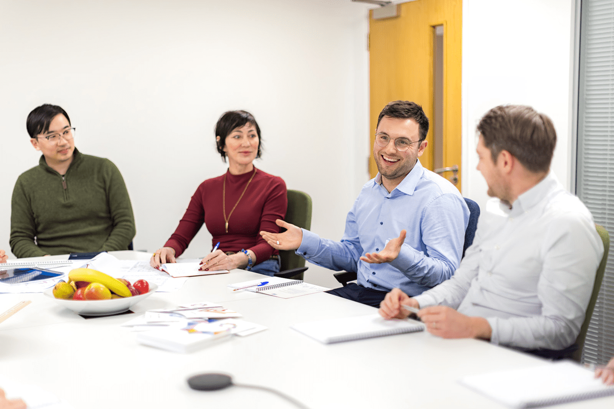 Employees around table in London office