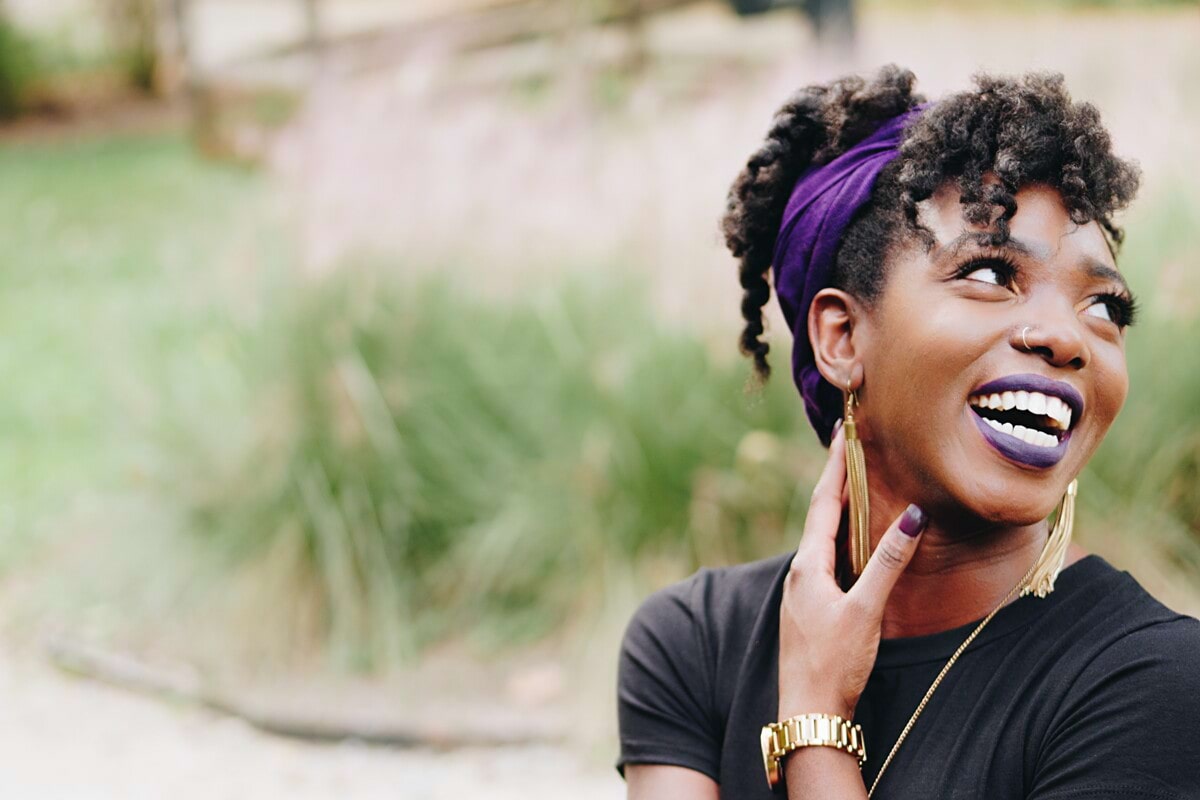 photo of woman wearing purple lipstick and black crew-neck shirt