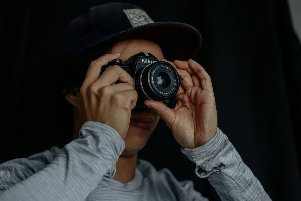 man taking photo using camera