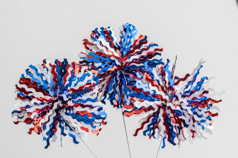 Two red, white and blue firecrackers in a vase