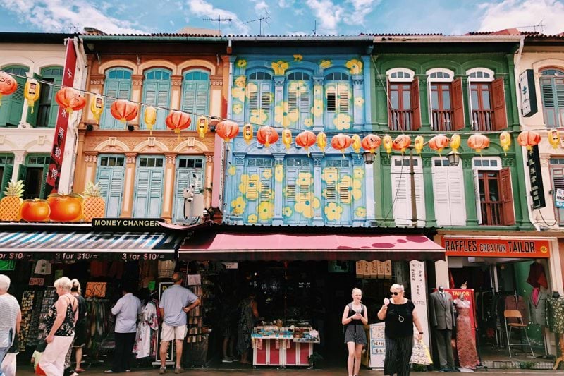people at multicolored painted store during daytie