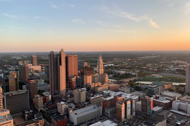 tall building lot under white clouds and blue sky during daytime