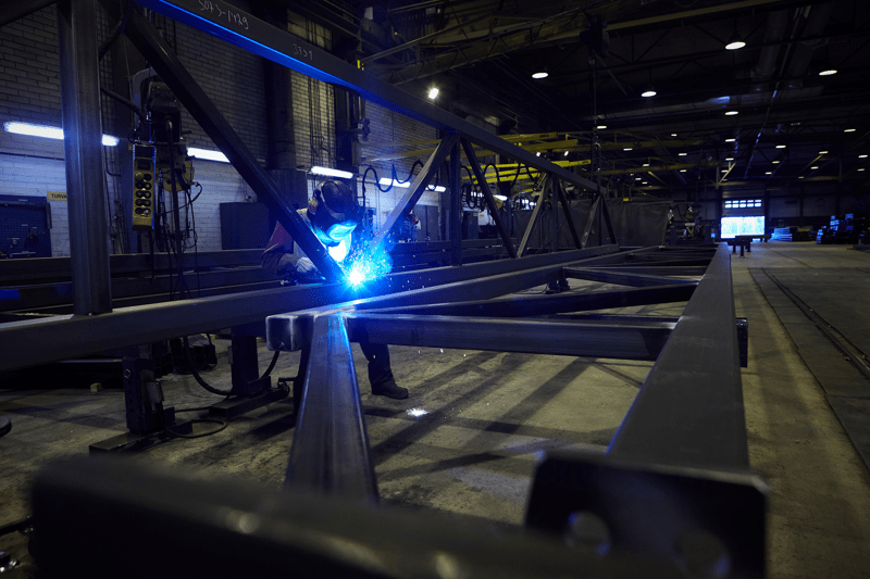 Welder working on a steel frame