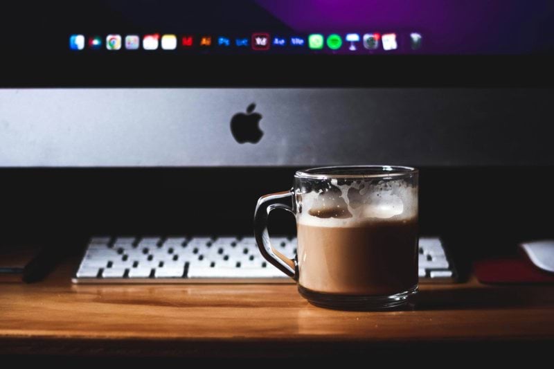 a cup of coffee sitting on top of a wooden table