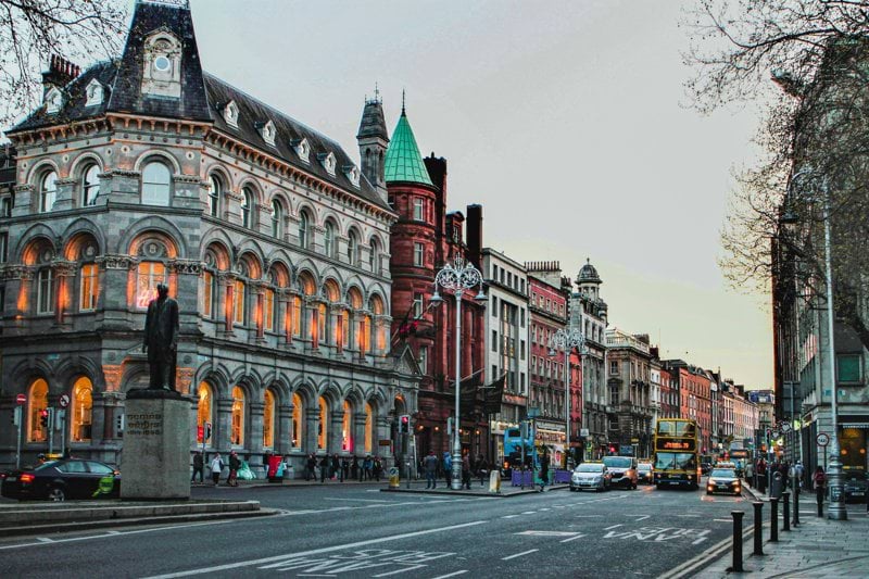 a city street with a clock tower in the middle of it
