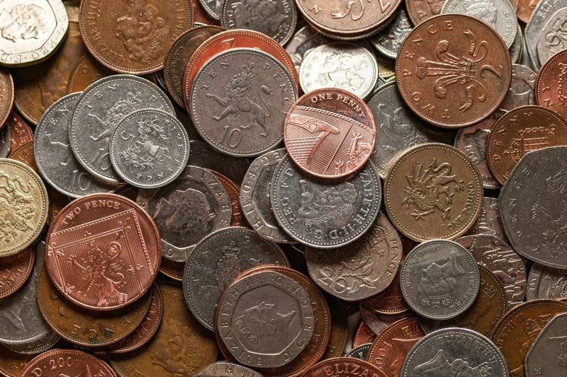 a pile of different types of coins