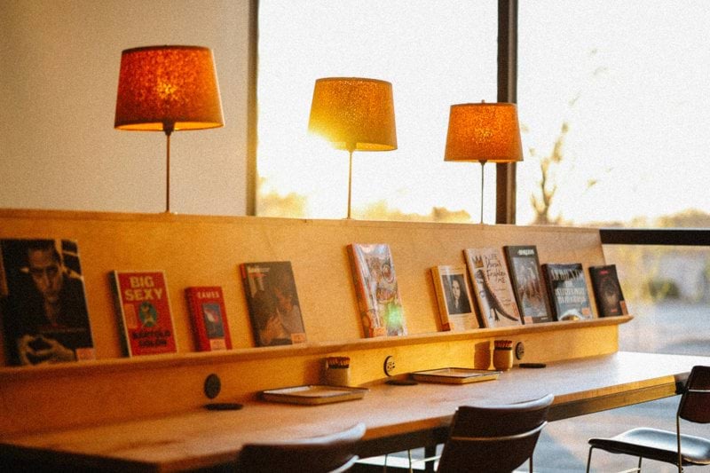 Warm lighting illuminates a modern reading space.