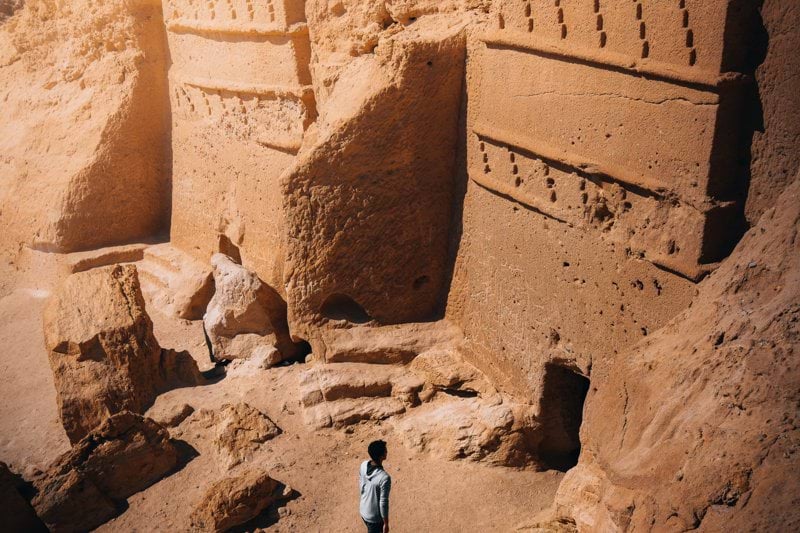 a man standing in front of some rocks
