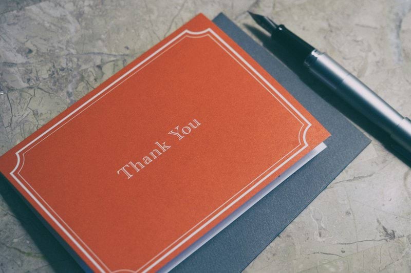 fountain pen next to red Thank You journal