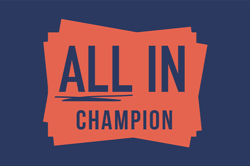 All In Champion logo with bold navy text on an orange layered background.