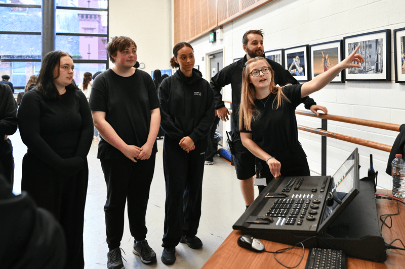 Member of staff presenting something on screen to a group of people.