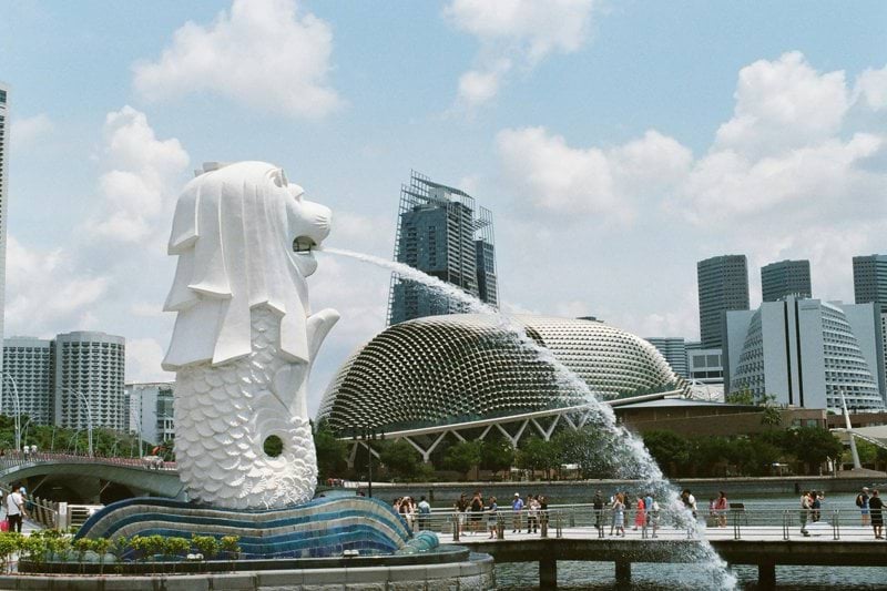 white concrete statue near city buildings during daytime