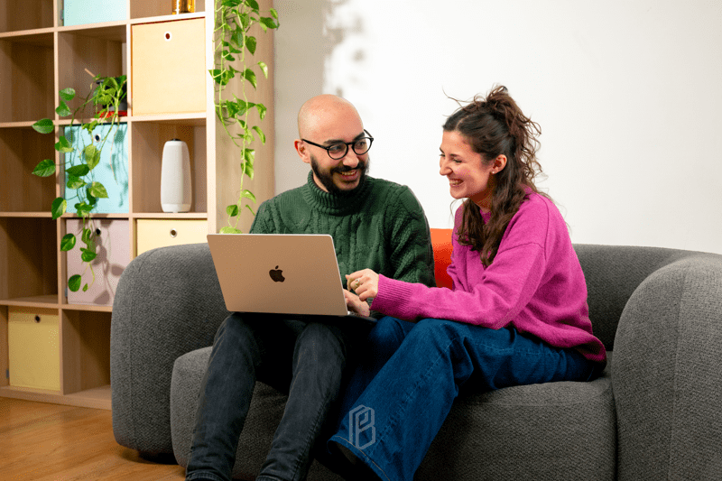 A man and a woman working on a computer