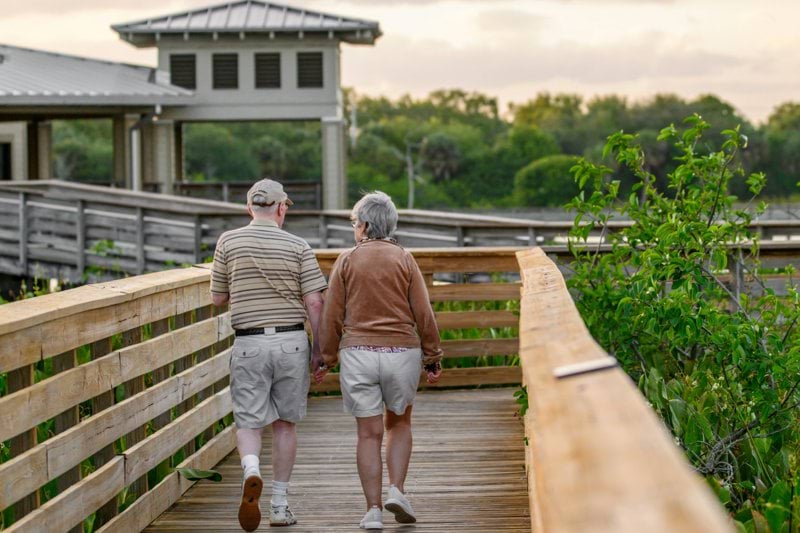 a couple of people that are walking on a bridge