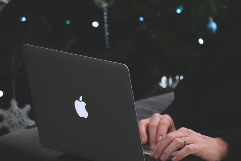 person using macbook air during nighttime