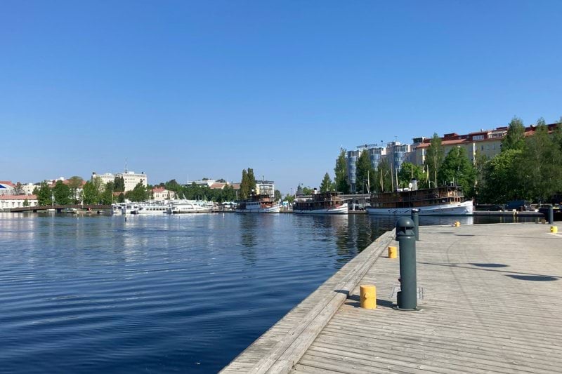 A body of water with a city in the background