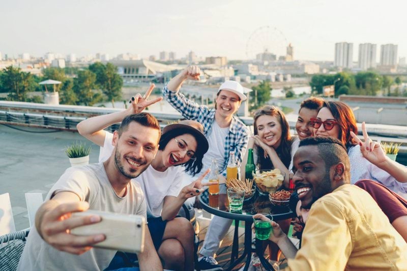 Group of friends taking a selfie on a rooftop