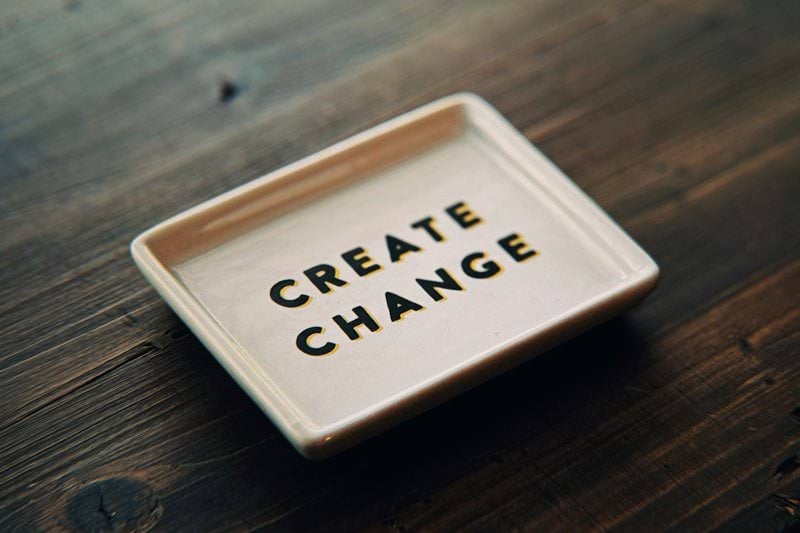 A white tray with the words create change written on it