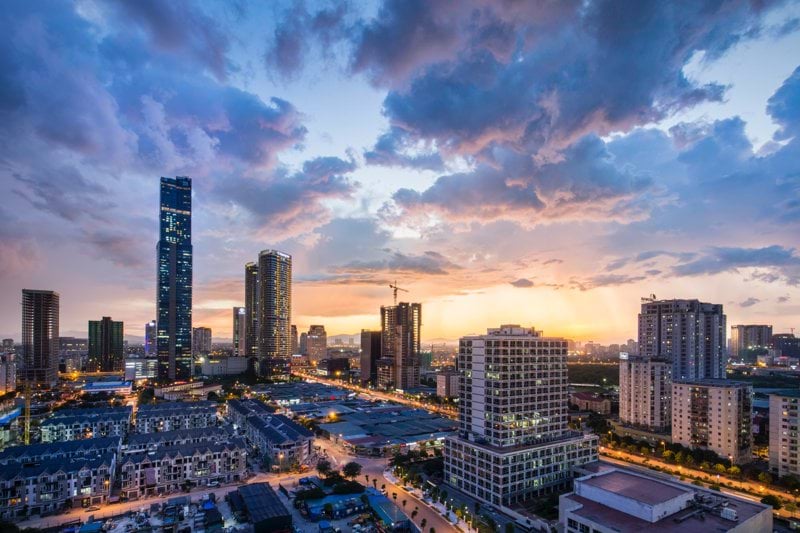 gray high-rise buildings under gray clouds during golden hour