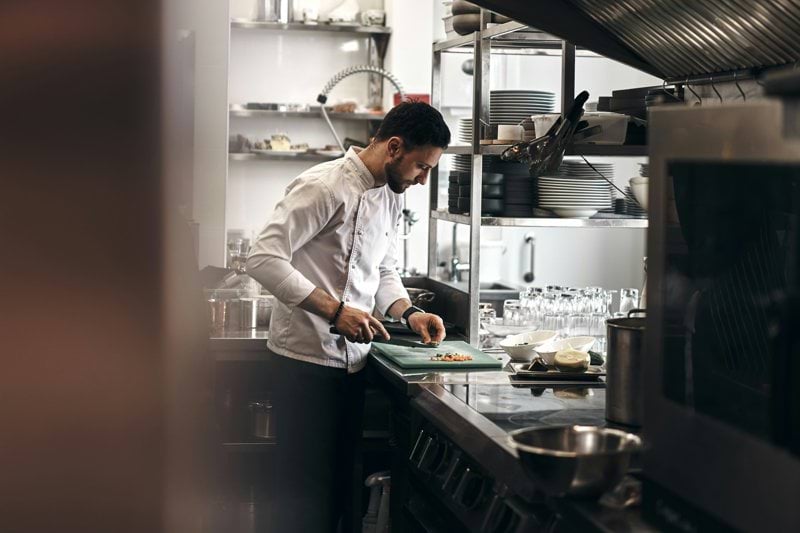 man in white dress shirt holding white ceramic plate