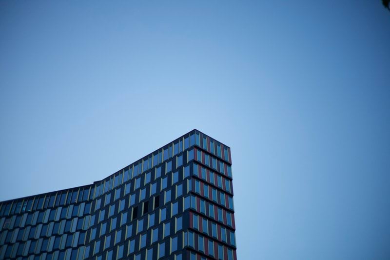 a tall building with many windows against a blue sky