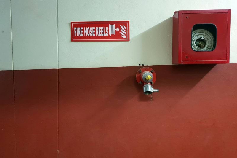 red metal fire hose reel container