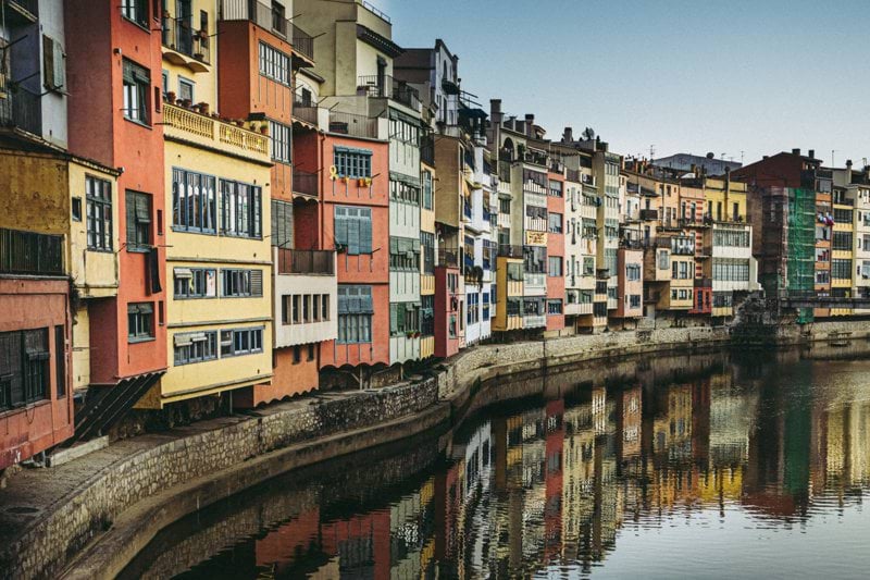 brown and white concrete building beside river during daytime