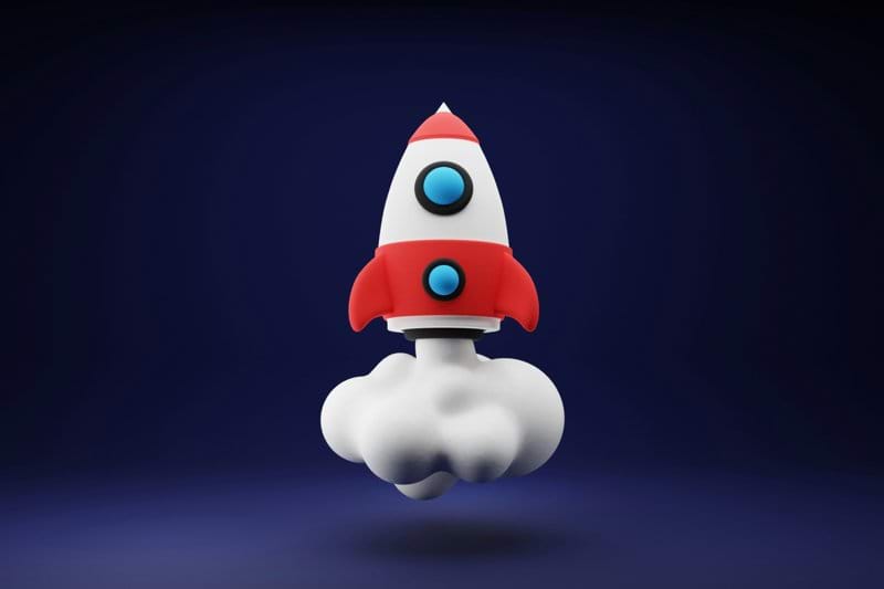 a red and white toy rocket on a blue background