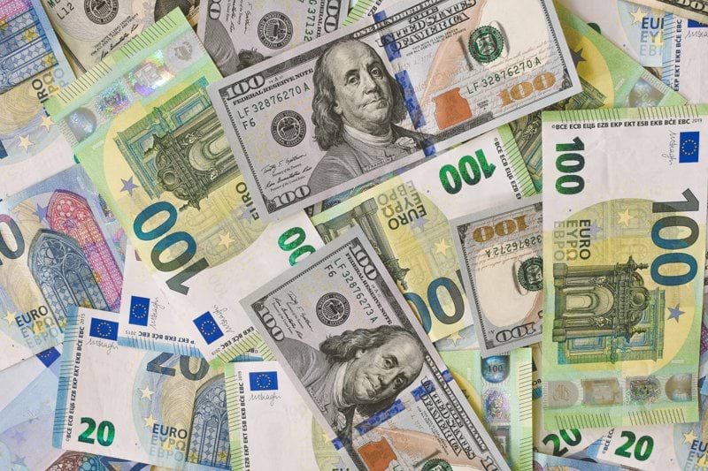 A pile of 20, 100 Euro (EUR), and 20, 100 Dollar (USD) banknotes.