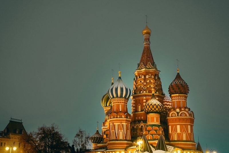 A very tall building with a clock on it's side