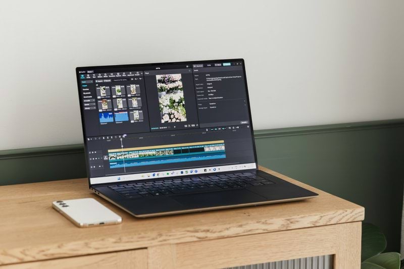 A laptop is displaying video editing software.