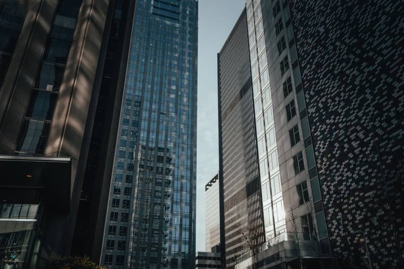 a couple of tall buildings sitting next to each other
