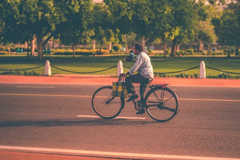 man riding bike on concrete pavement