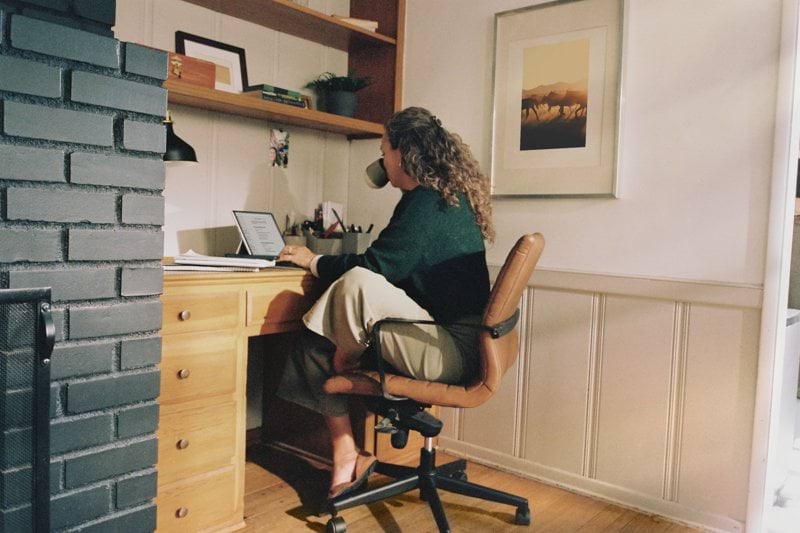 Woman working at desk with coffee