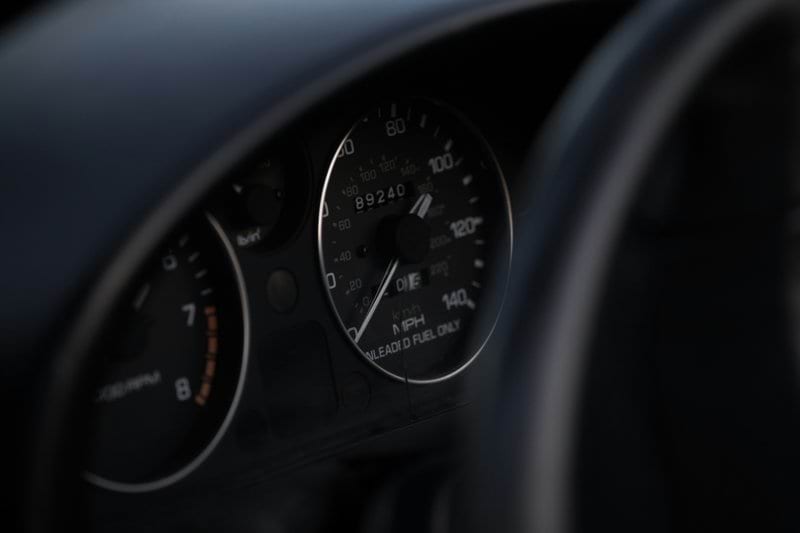 black vehicle speedometer