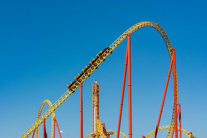 a roller coaster in an amusement park on a clear day