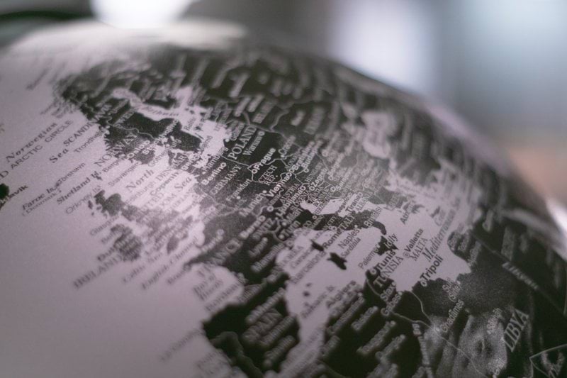 grayscale photo of desk globe