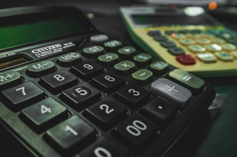 a calculator sitting on top of a table next to another calculator