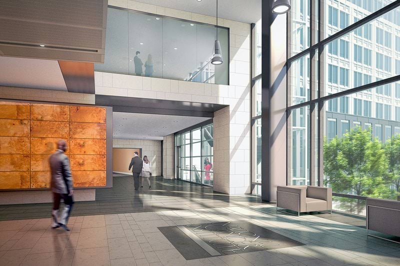 man in black jacket walking on white tiled floor