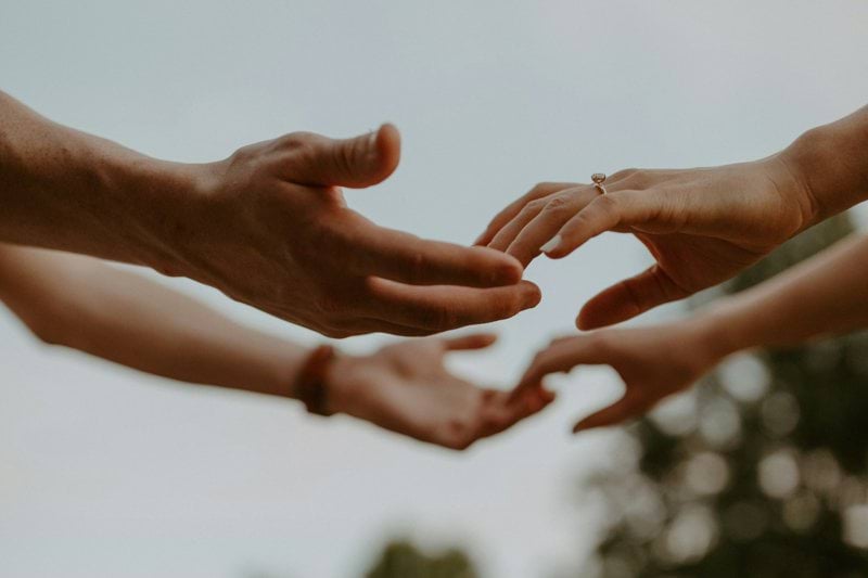 a group of people reaching out their hands
