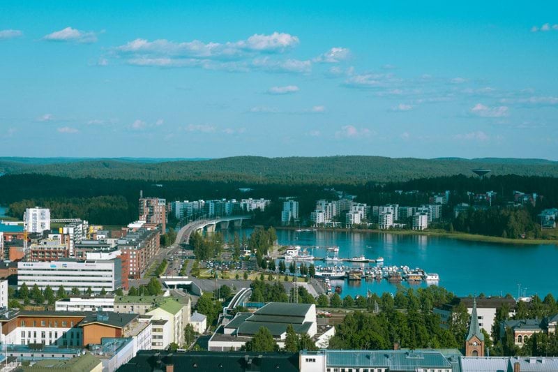 aerial view of city buildings near body of water during daytime