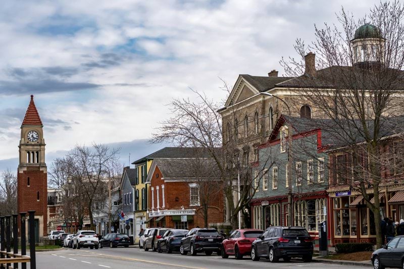 a city street with a clock tower in the background