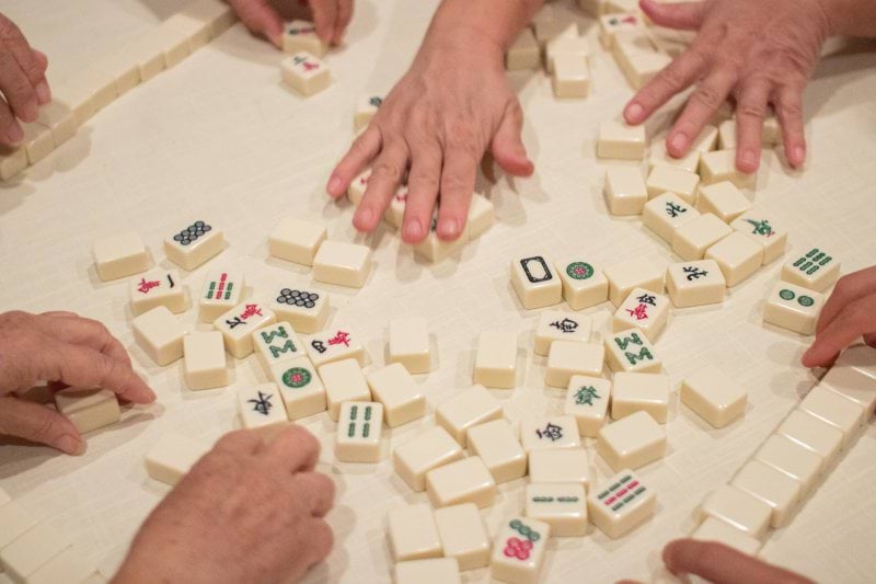 person playing white and brown lego blocks